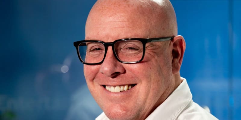 Nick Leeson smiling at camera, healthy colon cancer survivor at age 59