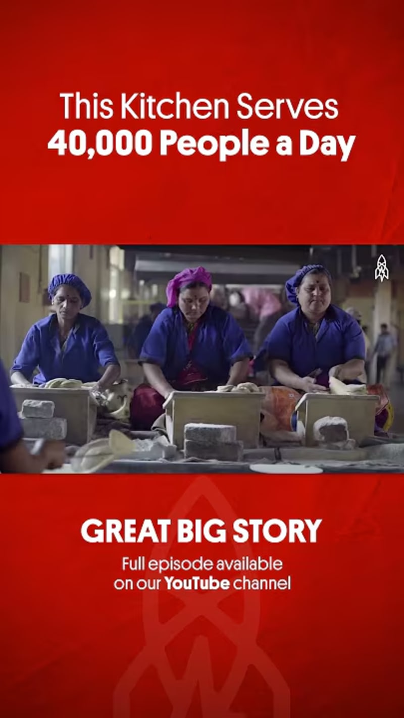 Large industrial kitchen with workers preparing massive quantities of food for temple visitors