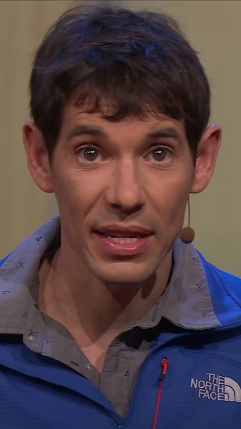 Rock climber Alex Honnold scaling vertical cliff face at El Capitan in Yosemite National Park