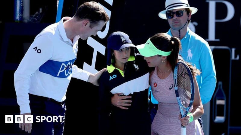 Turkish tennis player Zeynep Sonmez helping ball girl walk off court at Australian Open