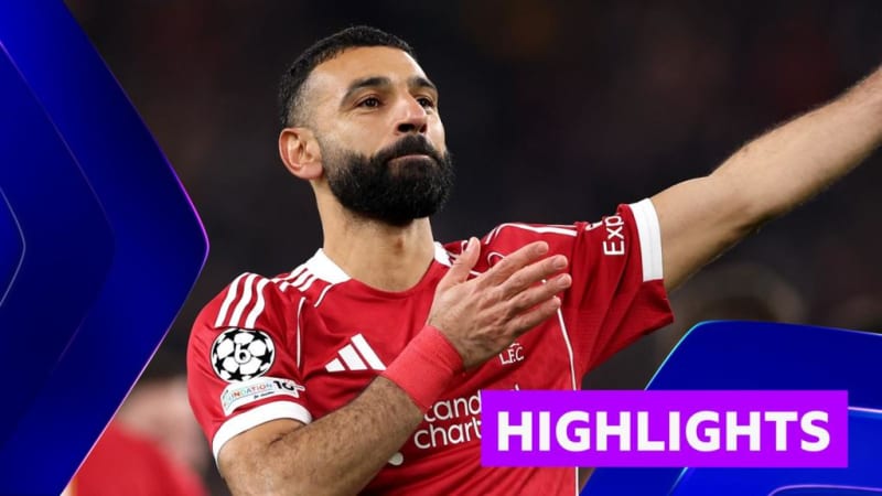 Liverpool players celebrating together on the pitch after scoring goal against Qarabag at Anfield stadium