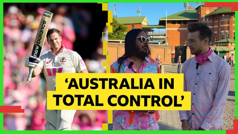 Cricket stadium during Ashes Test match with players on field and BBC broadcast equipment capturing the action