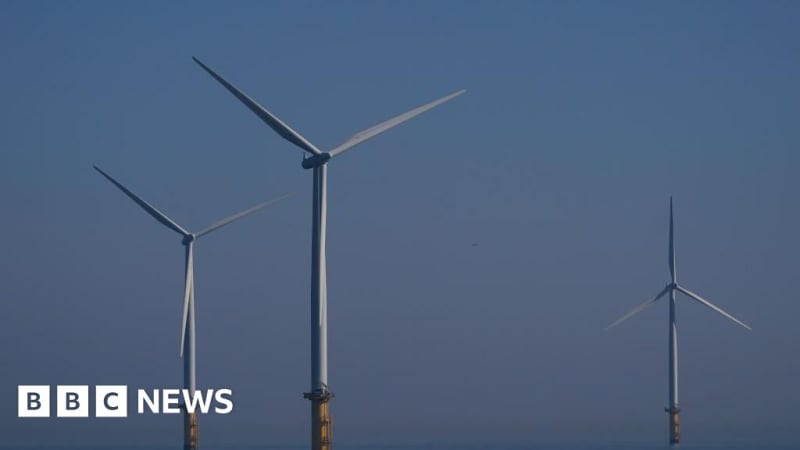 Offshore wind turbines standing in ocean waters generating renewable energy for coastal communities