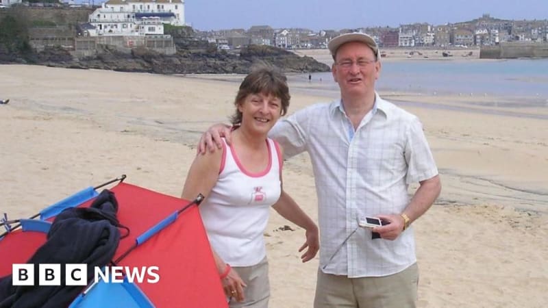 Richard Brailsford standing beside photo of his father Chris who battled Motor Neurone Disease