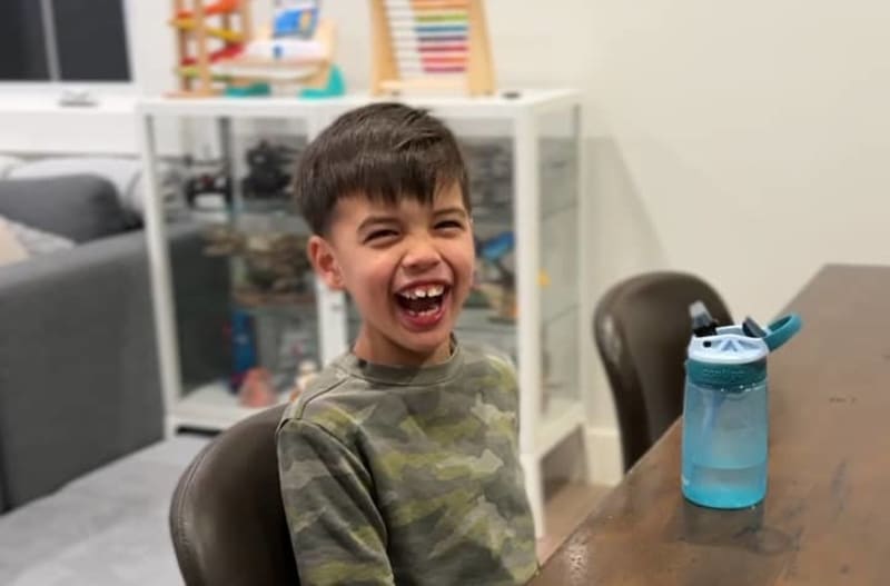 Father Jeff Allen smiling with young son Lucas who has creatine transporter deficiency