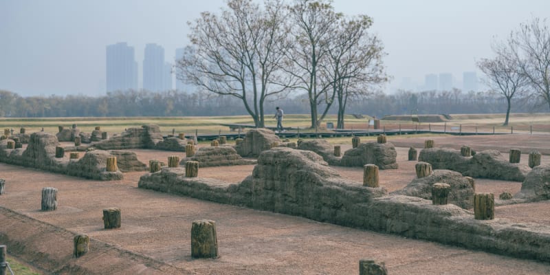 ** Archaeologists carefully excavate ancient trenches at Panlongcheng site in Wuhan, China during winter