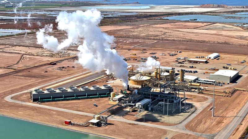 Geothermal drilling site with steam rising from underground renewable energy infrastructure