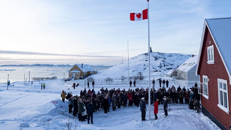 Canadian flag being raised outside new consulate building in snowy Nuuk, Greenland
