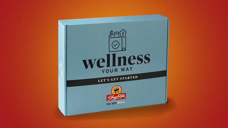 Blue ShopRite wellness starter kit box with diet guides and healthy food samples inside