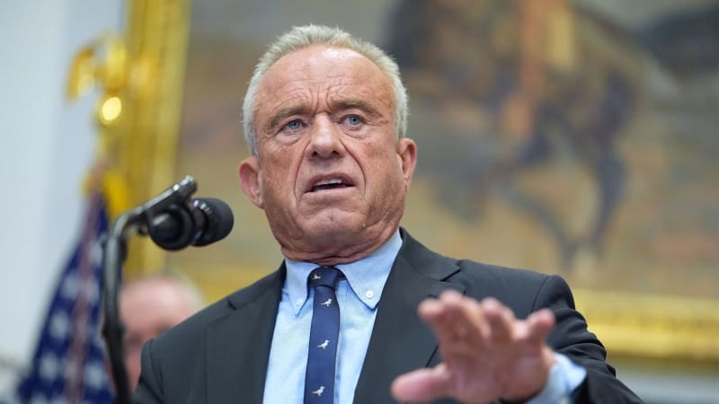 Pediatrician consulting with parents about child healthcare options in a bright, welcoming medical office setting