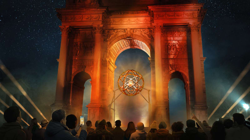 Crowds gathered at Milan's Arch of Peace viewing the illuminated moving Olympic cauldron at dusk