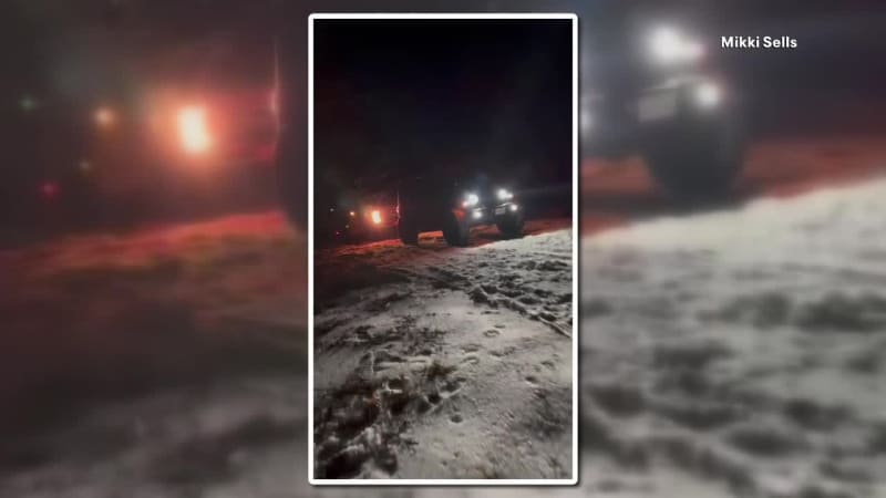 Off-road vehicle driving through snowy, icy conditions to transport healthcare workers in Texas