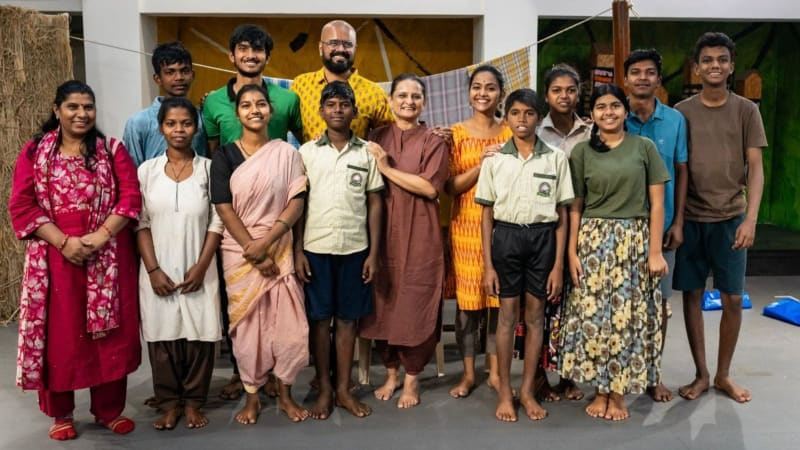 Children from Maharashtra villages performing traditional songs and dances on stage in the musical production Jikni