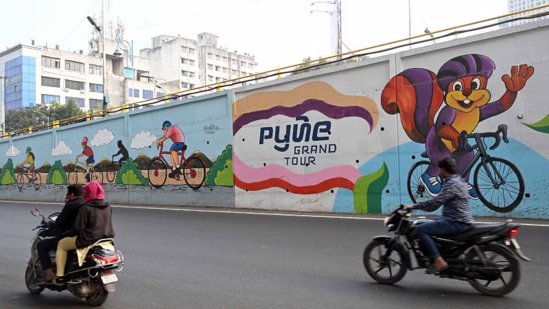 Professional cyclists racing through scenic routes during an international cycling tournament in Pune, India
