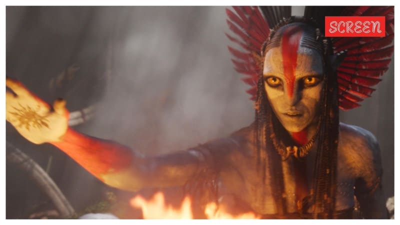 James Cameron celebrating at Avatar Fire and Ash premiere with glowing blue Avatar-themed background and enthusiastic crowd