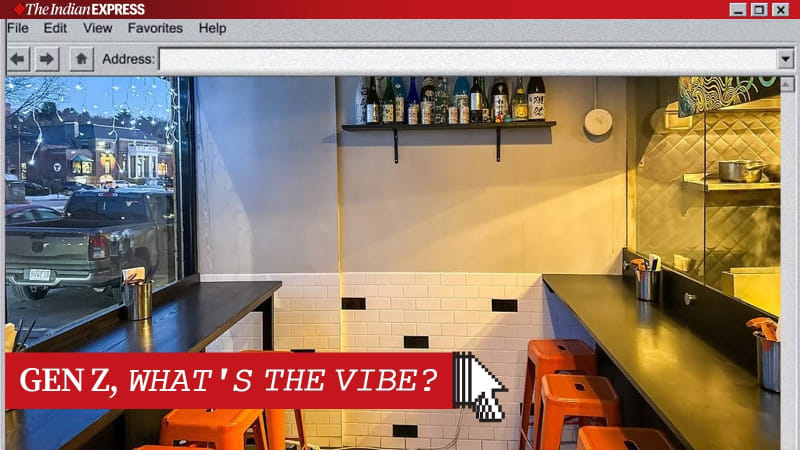 Young people enjoying food at a small, cozy restaurant with an open kitchen and intimate seating arrangement