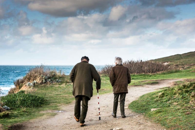 Older adult walking confidently outdoors showing improved mobility and independence from stem cell treatment