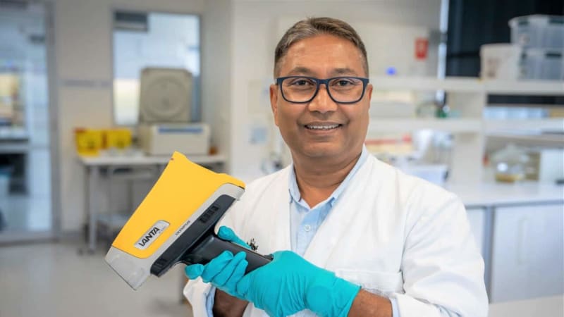 Scientist examining fish sample under advanced laboratory equipment to verify food origin