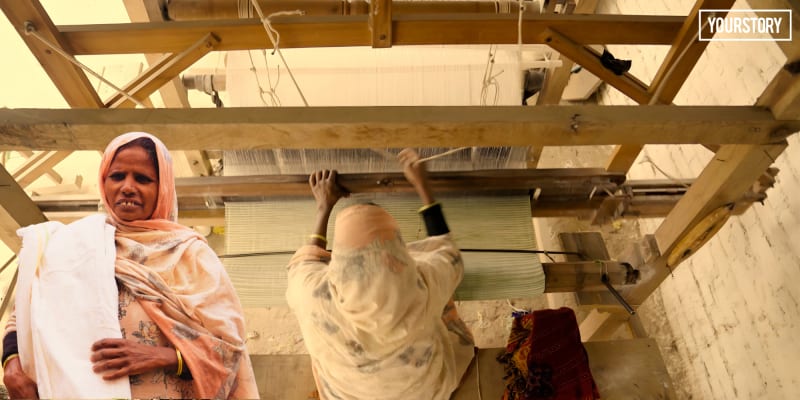Indian artisan weaving colorful cotton fabric on traditional wooden handloom in Hardoi workshop