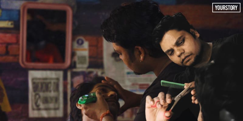 Local barber Deepak cutting customer's hair in his clean, well-organized neighborhood salon in Baghpat district