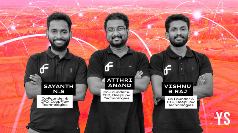 Indian farmers using mobile phones to check crop data in green agricultural fields