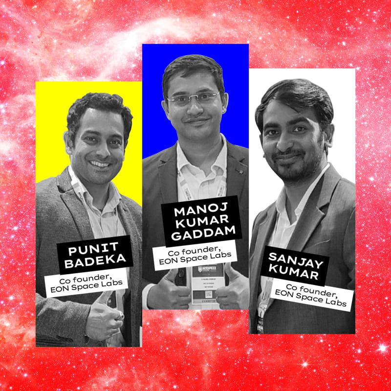 Scientists examining compact satellite camera system with precision optics in clean room laboratory