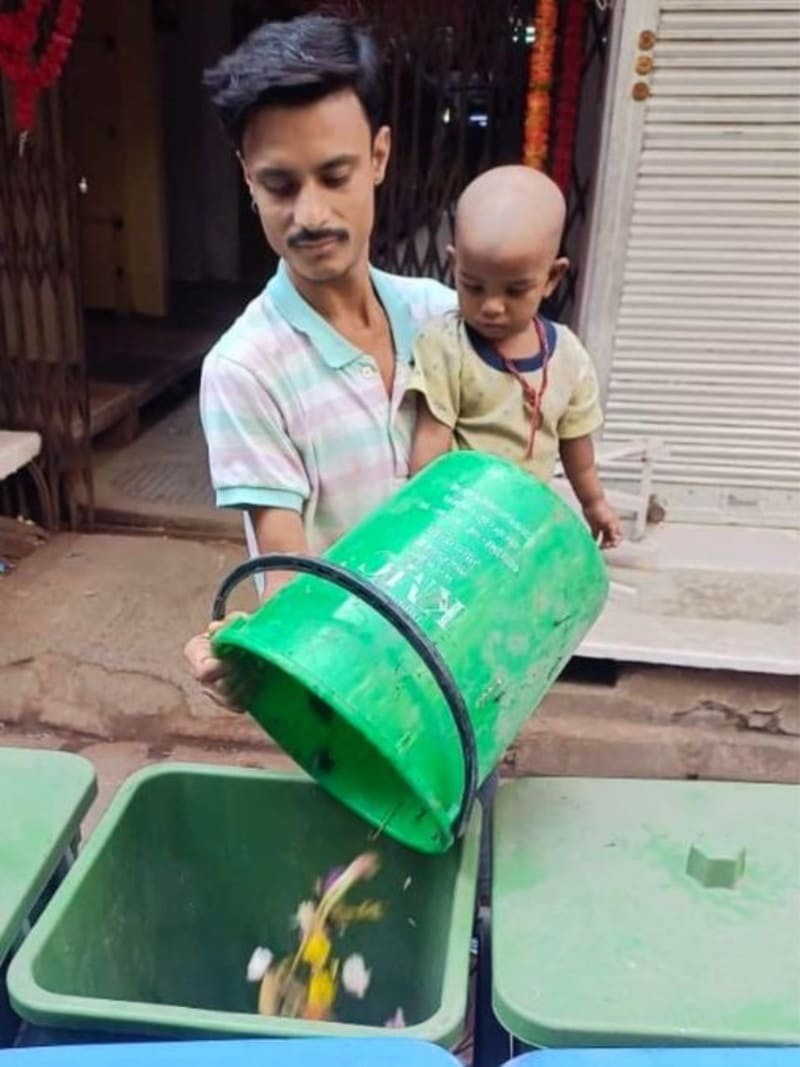 Four color-coded waste bins in green, blue, red, and yellow showing India's new segregation system