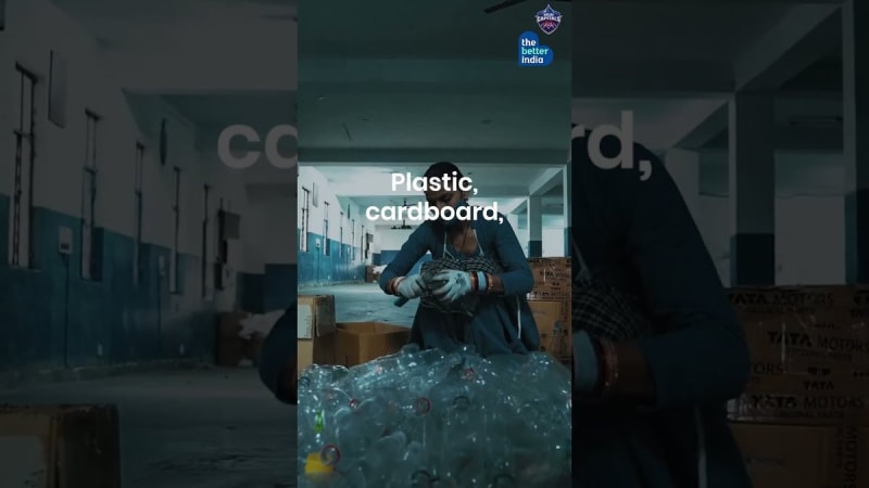 Two young brothers standing beside recycled waste materials in Delhi India