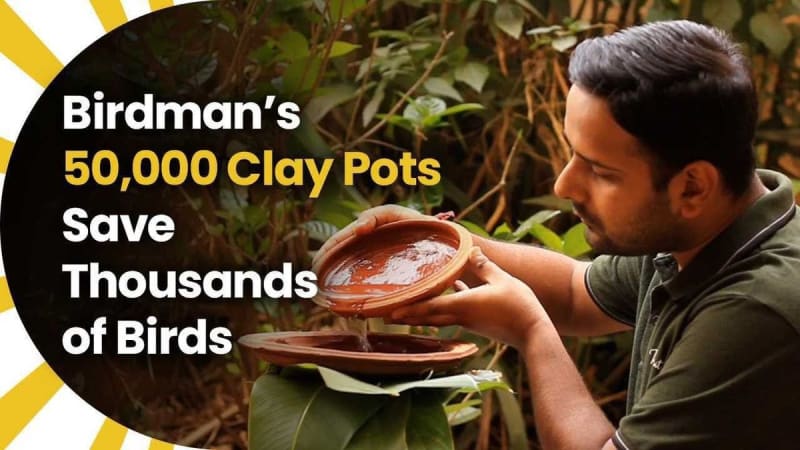 Man placing traditional clay water pots outdoors to provide drinking water for thirsty birds