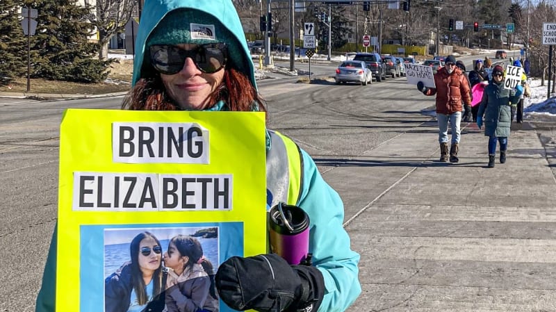 School social worker Tracy Xiong speaking at microphone during press conference about detained student Elizabeth