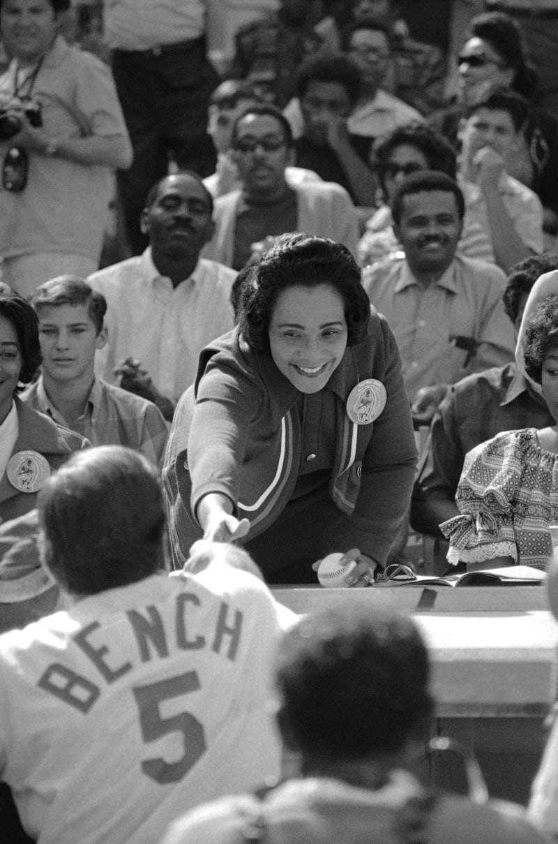** Coretta Scott King throwing ceremonial first pitch to Johnny Bench at 1970 MLK memorial game