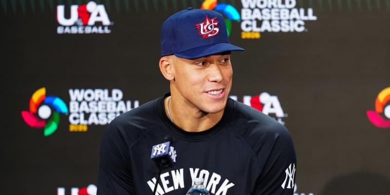 Aaron Judge in New York Yankees uniform smiling, representing his role as Team USA captain for World Baseball Classic