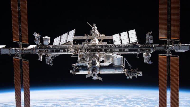 International Space Station orbiting Earth with researchers collaborating on groundbreaking space science experiments and discoveries