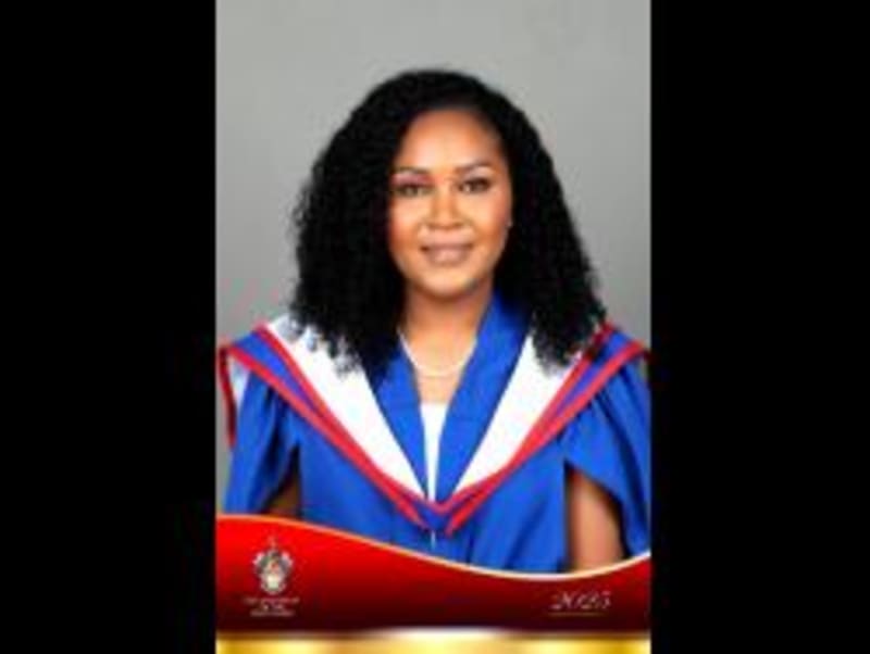 Renard Raymond and Cleopatra Young wearing graduation gowns after earning master's degrees on their birthdays
