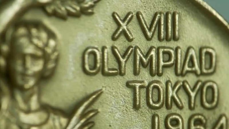 Olympic gold medals resting on table, replicas of Al Oerter's historic four consecutive wins