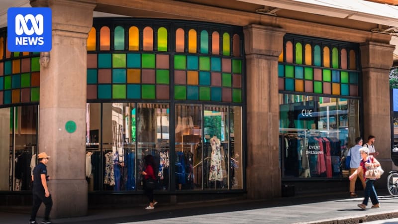 The iconic Queen Victoria Building in Sydney featuring distinctive coloured glass windows along its historic Romanesque sandstone facade