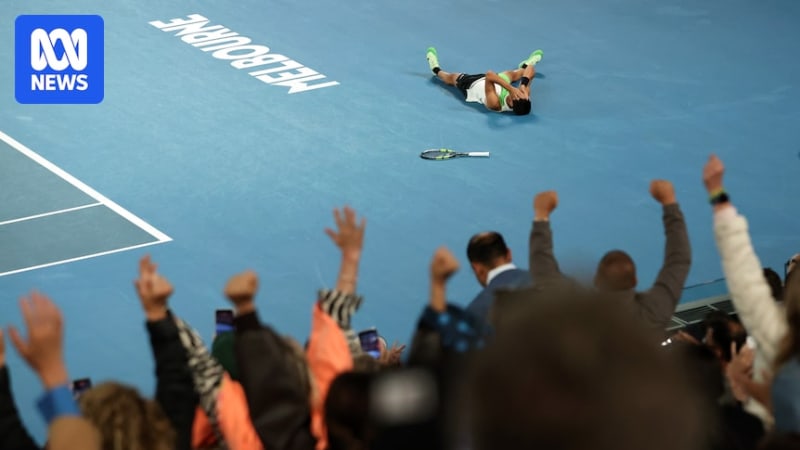Carlos Alcaraz holds Australian Open trophy overhead celebrating historic career Grand Slam victory
