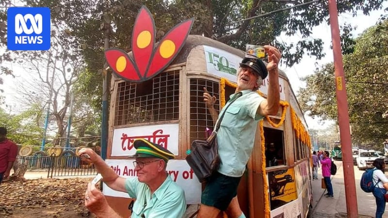 Colorful decorated tram in Kolkata during Tramjatra festival celebration with enthusiastic crowds gathered around in celebration