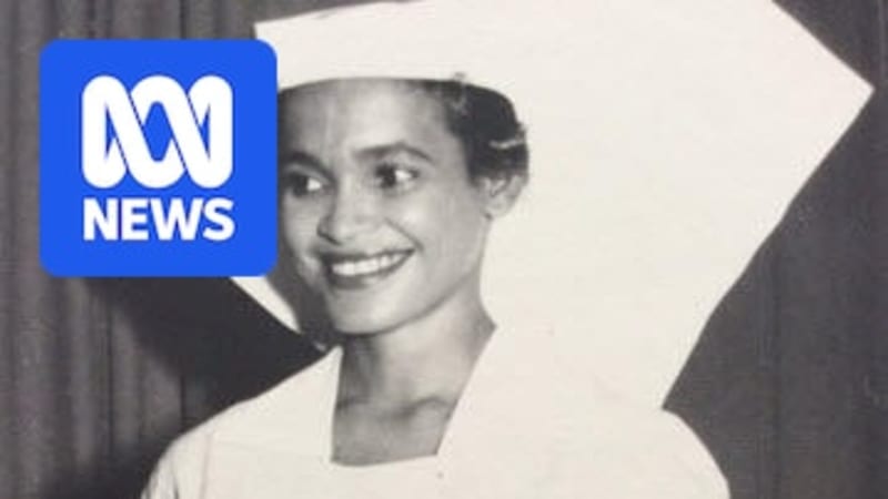 Professor MaryAnn Bin-Sallik smiling, wearing academic regalia at graduation ceremony