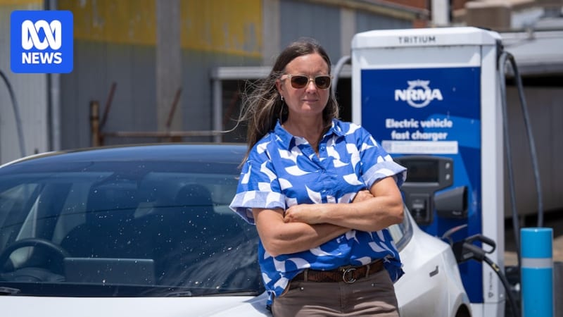 ** Community battery installation with safety features in Australian town parking lot near solar panels