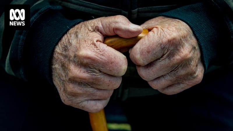 Elderly person in aged care facility receiving vaccine from healthcare worker smiling