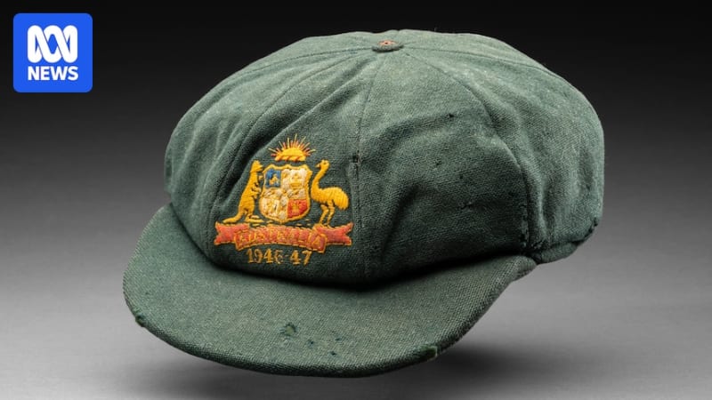 Sir Donald Bradman's green cricket cap with inscribed names displayed at auction house