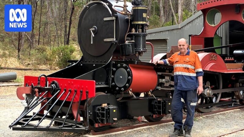 Glen Smythe's handmade steam locomotive being lifted by crane onto transport truck