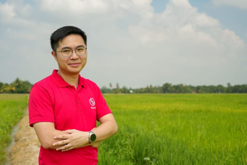 Agricultural drone spraying crops over green farmland in Southeast Asia