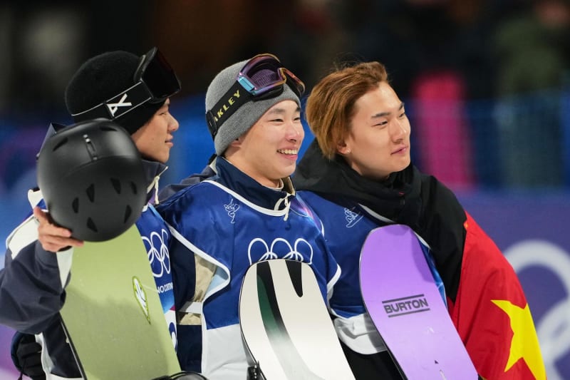 Japanese snowboarders Kimura and Kimata holding gold and silver medals on Olympic podium