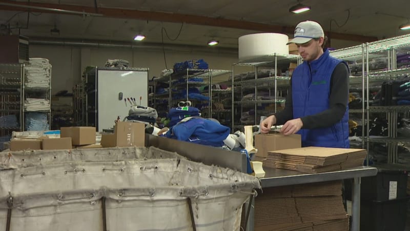 Stacked shipping boxes at Simply Seattle warehouse preparing Seahawks championship merchandise orders