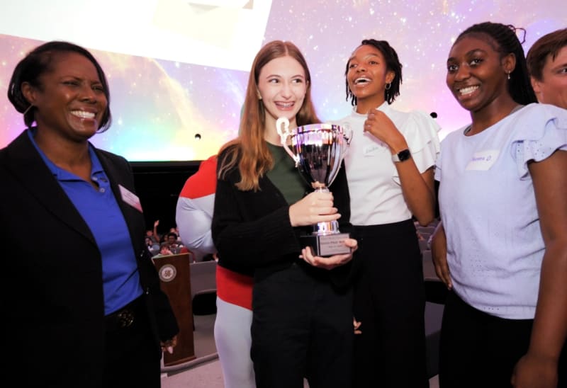 Middle school student Maximo Luciani plants live stakes along Bubbling Creek for erosion control project