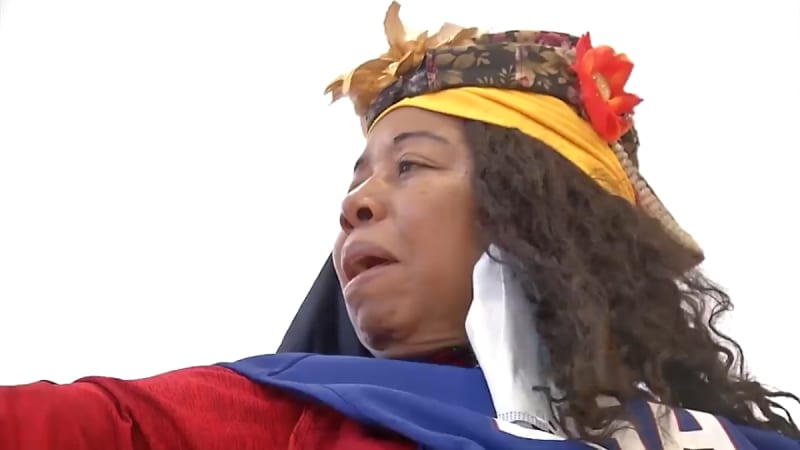 Army veteran Babette Peyton practicing archery with adaptive technique at training center