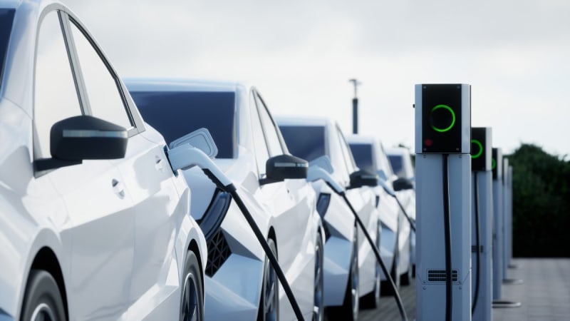 Row of modern electric vehicles parked at a dealership lot awaiting new buyers