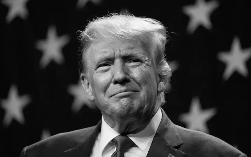Prescription medication bottles arranged on table with TrumpRx discount platform displayed on computer screen